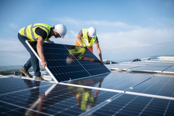 Commercial solar installers fitting rooftop panels on an Australian business