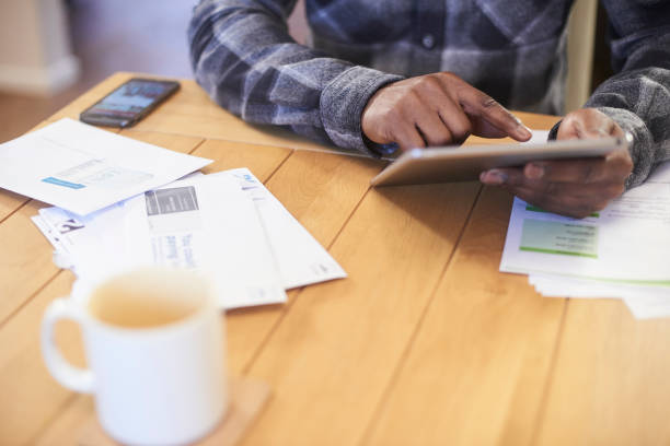 Person reviewing energy and gas bills on a tablet at home