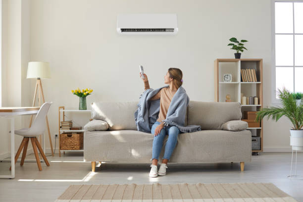 Australian homeowner using a heat pump air conditioning system to reduce energy costs