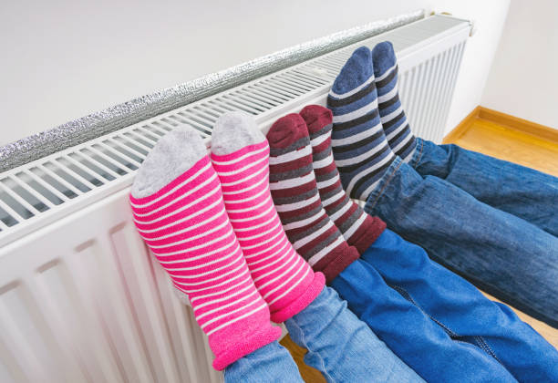 Socks warming on a household radiator, representing gas and electric home heating in winter